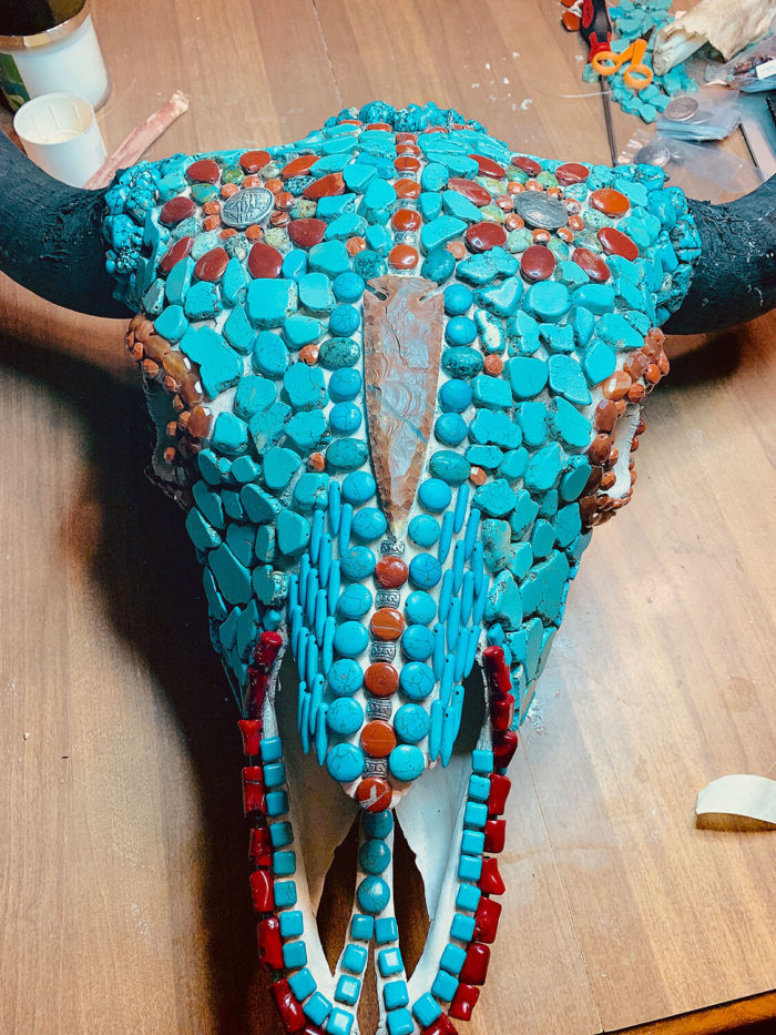 Bison bull skull with silver conches before grout